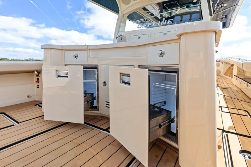 Slide: The Image of 2023 HCB 53 Suenos RXV boat interior with open storage compartments and sleek design. - 24