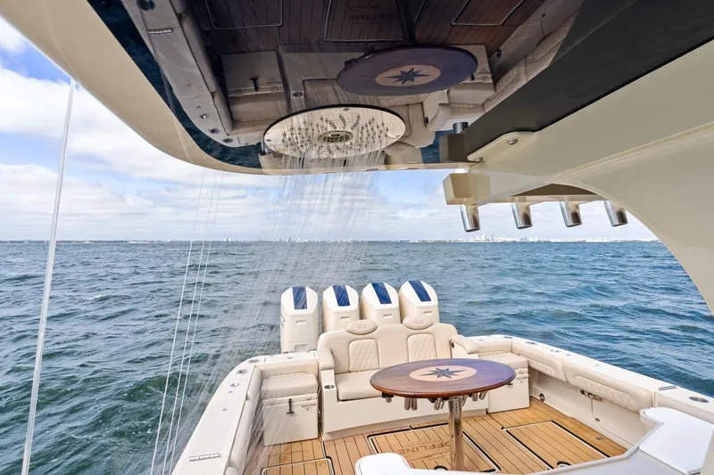 Slide: The Image of 2023 HCB 53 Suenos RXV luxury boat with shower and seating on open water. - 33