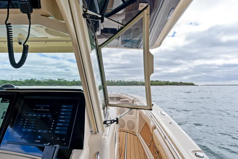 Slide: The Image of 2023 HCB 53 Suenos RXV boat interior with open window, overlooking calm waters. - 7