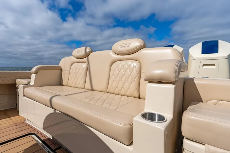 Slide: The Image of Luxurious seating on 2023 HCB 53 Suenos RXV boat under a partly cloudy sky. - 14