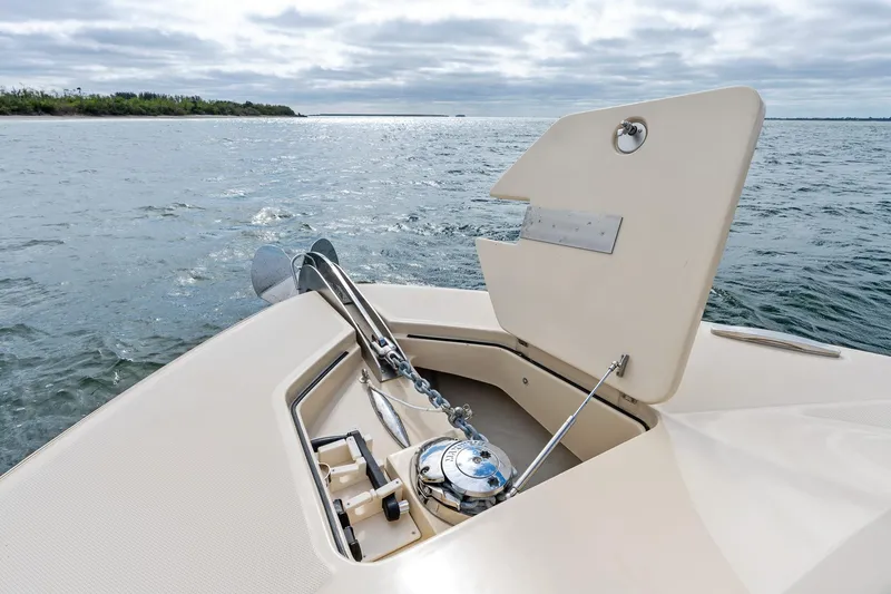 Slide: The Image of 2023 HCB 53 Suenos RXV boat anchor compartment open on calm water. - 20