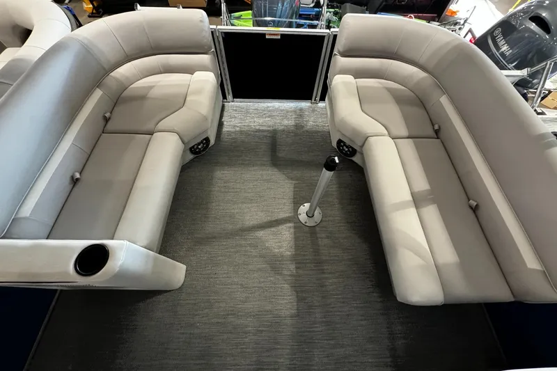 Slide: The Image of Interior seating of 2026 Godfrey Xperience 2286 SBX Sport Tube boat, featuring plush gray upholstery. - 2