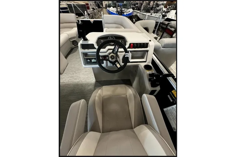 Slide: The Image of Interior view of 2026 Godfrey Xperience 2286 SBX Sport Tube boat, featuring steering console and seating. - 4