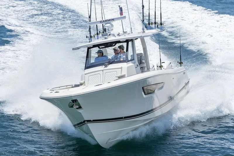 Slide: The Image of Manufacturer Provided Image: 2026 Pursuit S 388 Sport boat cruising on open water, showcasing sleek design and performance. - 4
