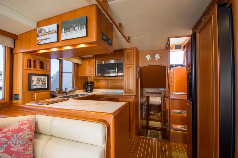 Slide: The Image of Luxurious interior of a 2015 Fleming 55 yacht with wood finishes and modern amenities. - 10