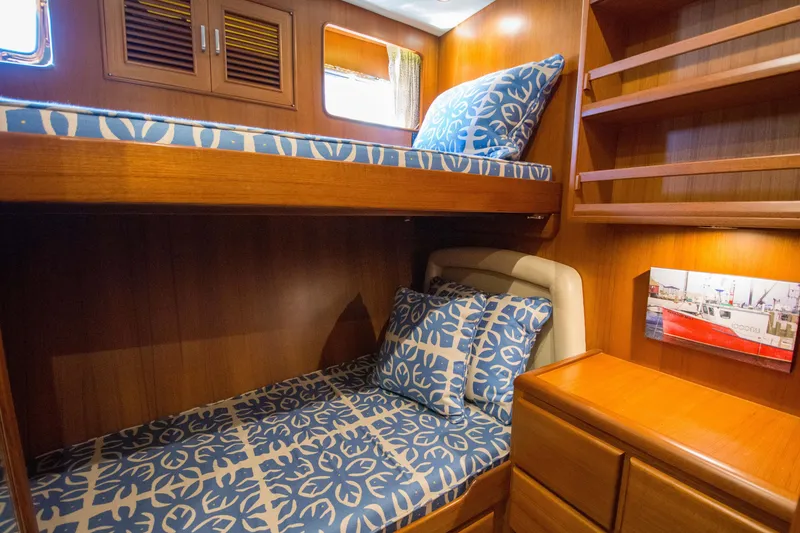 Slide: The Image of Cozy cabin interior of 2015 Fleming 55 yacht with bunk beds and wooden finish. - 12