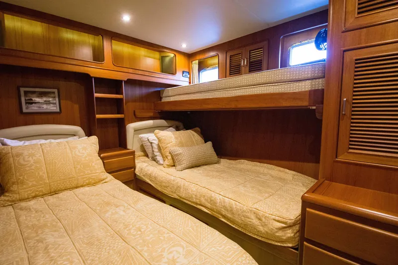 Slide: The Image of Luxurious cabin interior of a 2015 Fleming 55 yacht with wooden furnishings and cozy bedding. - 13