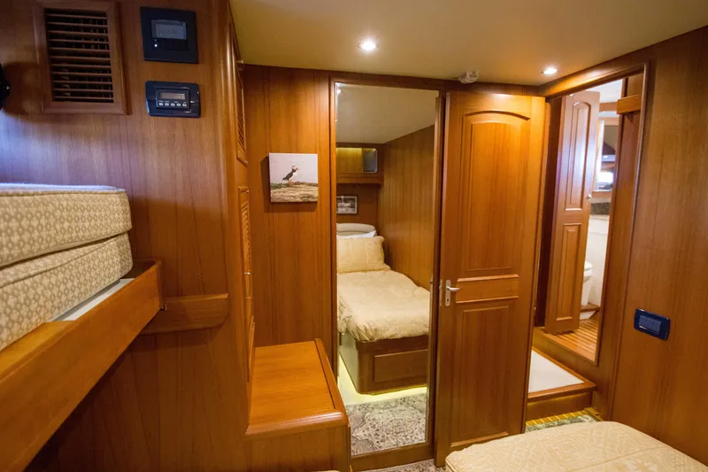 Slide: The Image of Interior of 2015 Fleming 55 yacht with cozy wooden cabin and bed. - 14