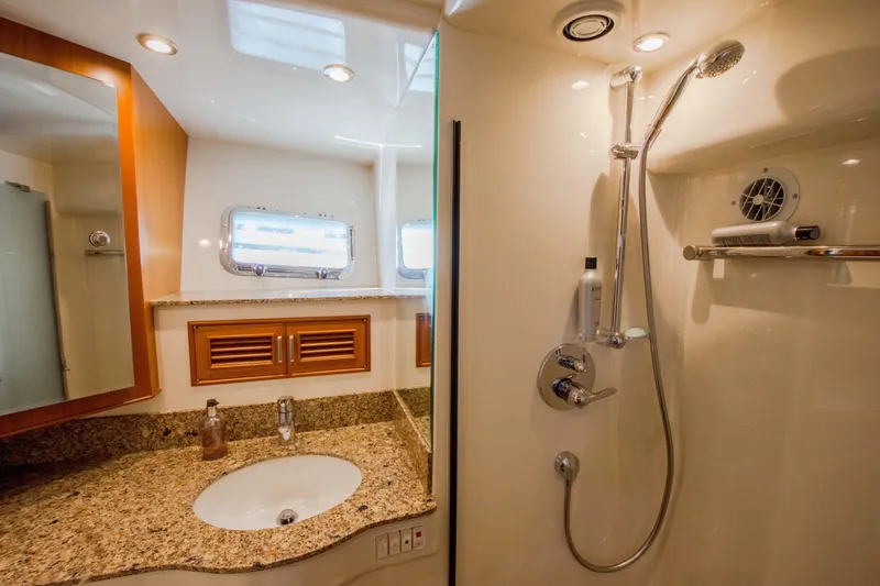 Slide: The Image of Luxurious bathroom in 2015 Fleming 55 yacht with granite countertop and modern shower. - 16