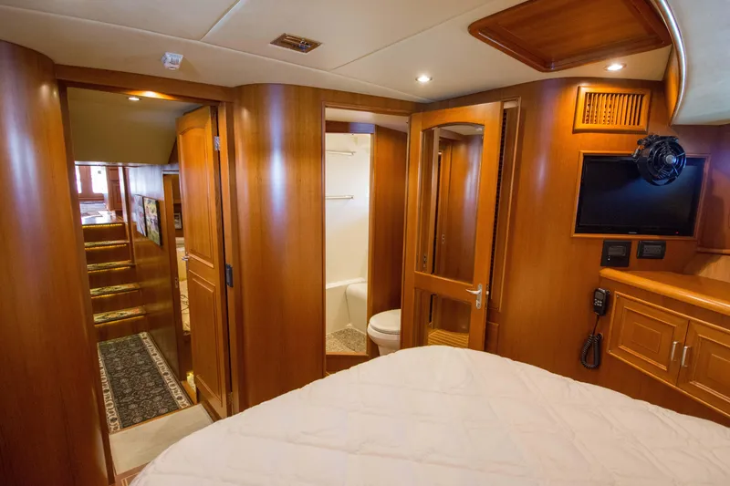 Slide: The Image of Luxurious 2015 Fleming 55 yacht interior with wood finish, bedroom, and bathroom. - 19