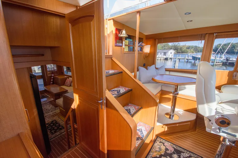 Slide: The Image of Luxurious interior of 2015 Fleming 55 yacht with wooden finishes and marina view. - 21