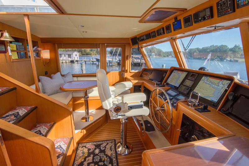 Slide: The Image of Luxurious 2015 Fleming 55 yacht interior with navigation equipment and seating area. - 22