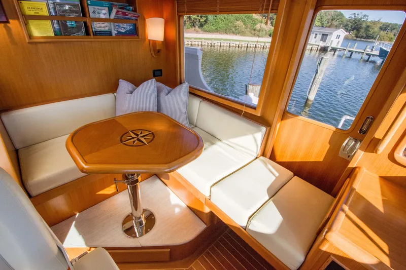 Slide: The Image of Cozy dining area in a 2015 Fleming 55 yacht with waterfront view. - 24