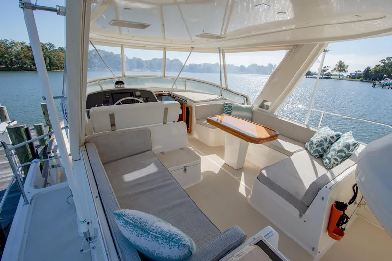 Slide: The Image of 2015 Fleming 55 yacht interior with seating, table, and scenic water view. - 29