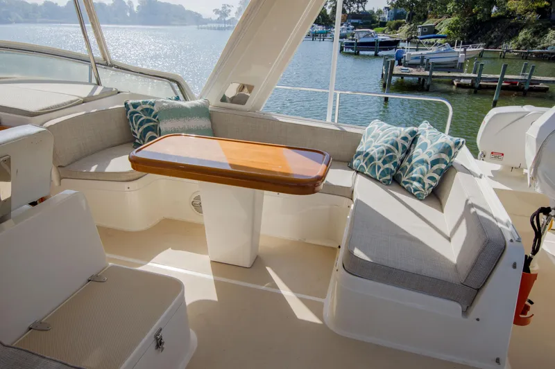 Slide: The Image of Luxurious seating area on a 2015 Fleming 55 yacht with scenic waterfront view. - 30