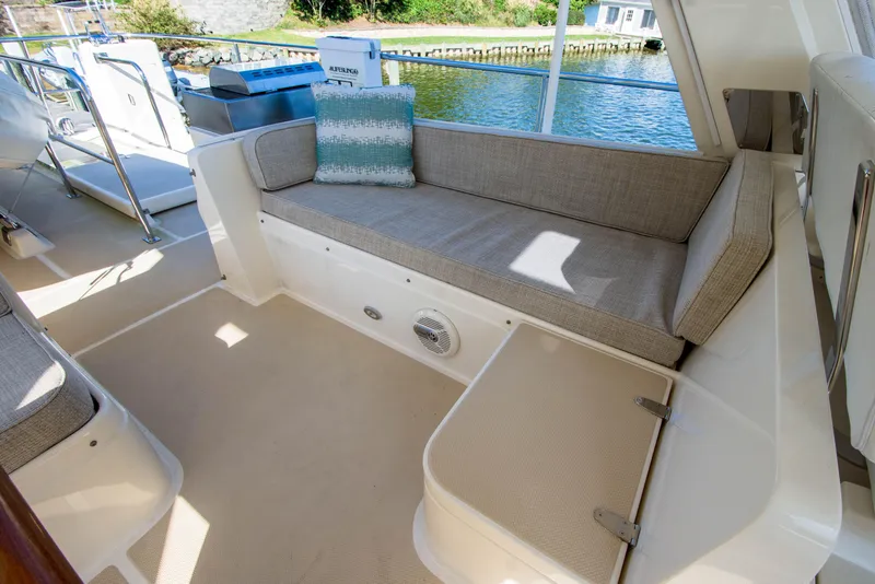 Slide: The Image of Luxurious seating area on a 2015 Fleming 55 yacht, featuring comfortable cushions and scenic water views. - 31