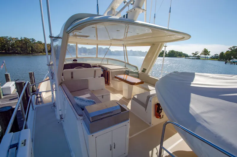Slide: The Image of Luxurious 2015 Fleming 55 yacht interior with seating area, docked by a serene lake. - 33