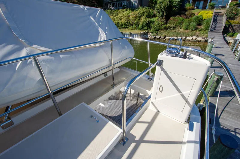 Slide: The Image of 2015 Fleming 55 yacht deck with railing and covered seating area. - 36