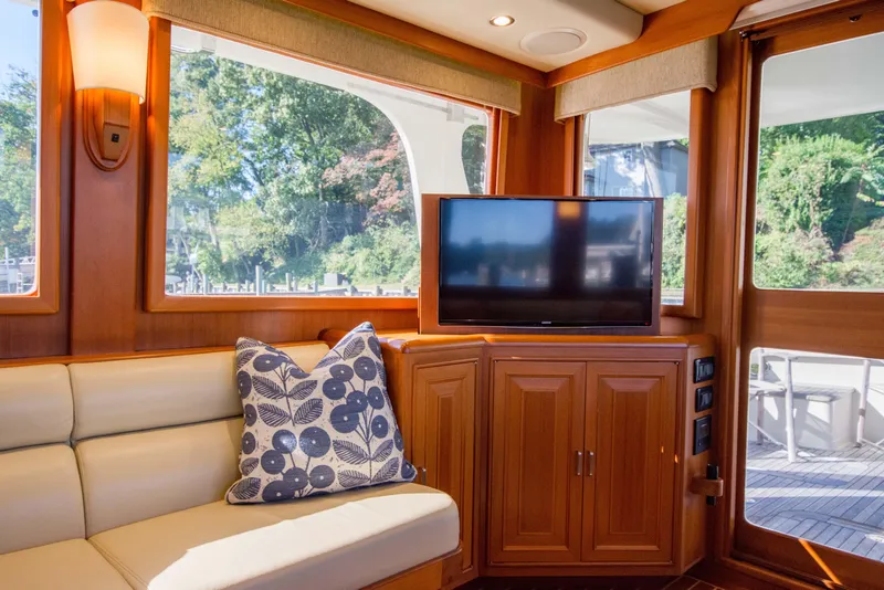 Slide: The Image of Luxurious interior of 2015 Fleming 55 yacht with TV, sofa, and decorative pillow. - 4
