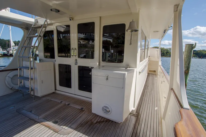 Slide: The Image of Deck view of 2015 Fleming 55 yacht with wooden flooring and stainless steel ladder. - 40