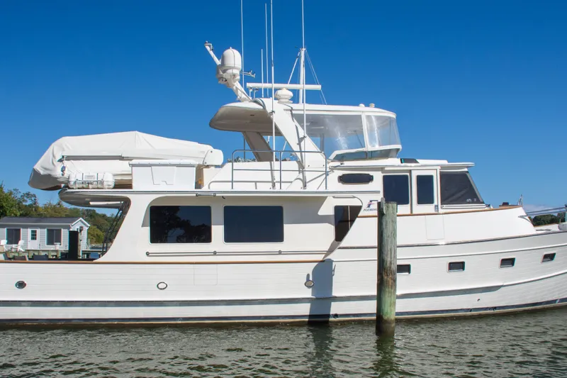 Slide: The Image of 2015 Fleming 55 yacht docked on a sunny day with clear blue sky. - 42