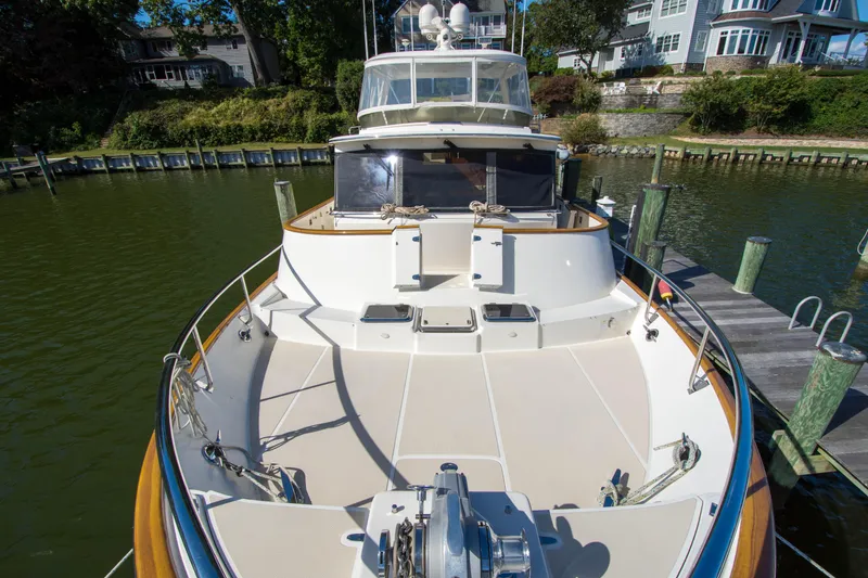 Slide: The Image of Luxury Fleming 55 yacht docked, showcasing spacious deck and elegant design, 2015 model. - 43