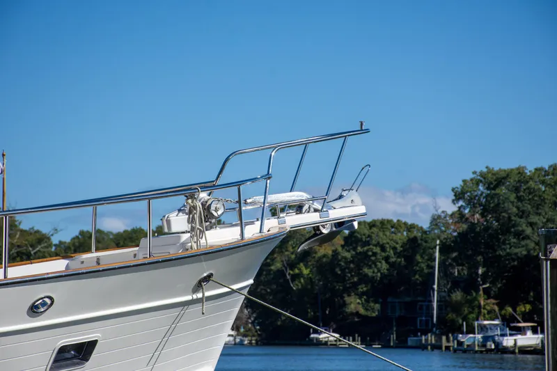 Slide: The Image of Bow of a 2015 Fleming 55 yacht docked by a scenic waterfront. - 46