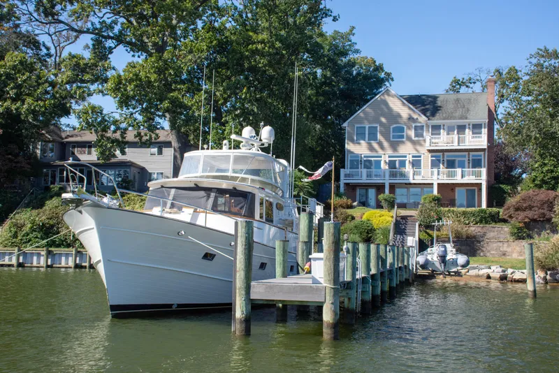Slide: The Image of Luxury Fleming 55 yacht docked near waterfront home, 2015 model. - 48