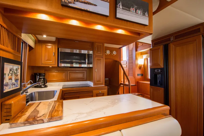 Slide: The Image of Luxurious 2015 Fleming 55 yacht interior with modern kitchen and wooden cabinetry. - 7