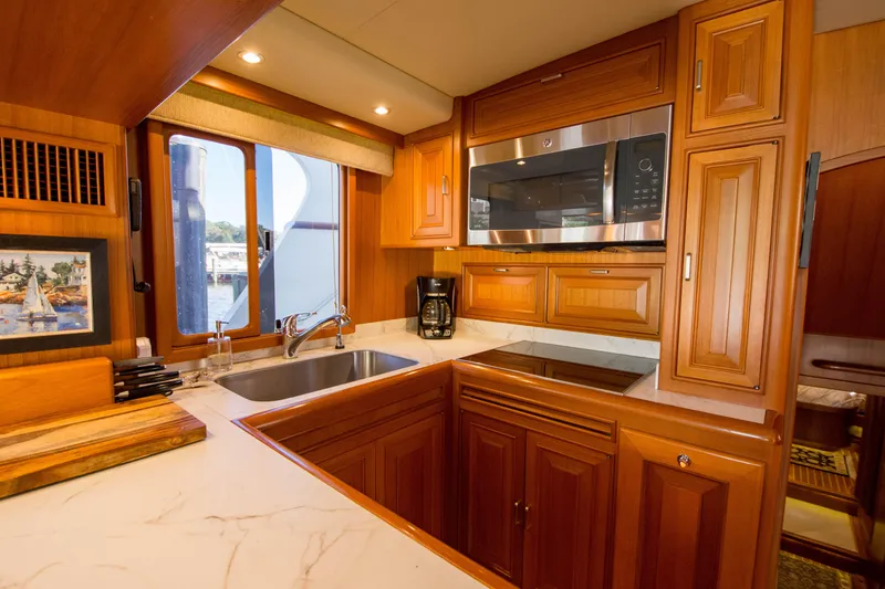 Slide: The Image of Luxurious kitchen interior of 2015 Fleming 55 yacht with wooden cabinetry and modern appliances. - 8