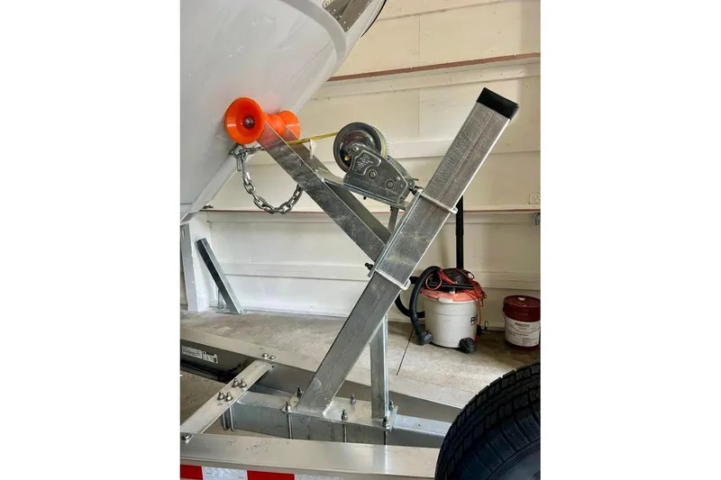 Slide: The Image of 2025 Cutwater C-248 Coupe docked at a marina, surrounded by calm water and greenery. - 19