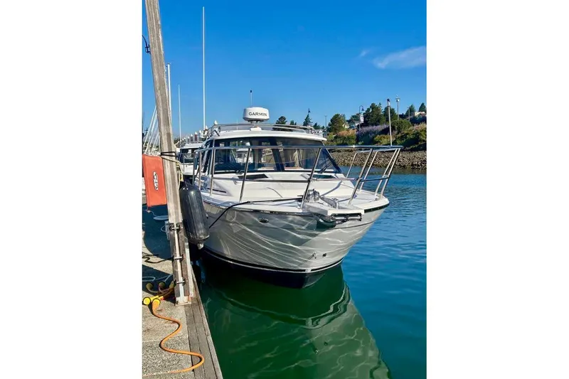 Slide: The Image of 2025 Cutwater C-248 Coupe docked in a marina under clear blue skies. - 3