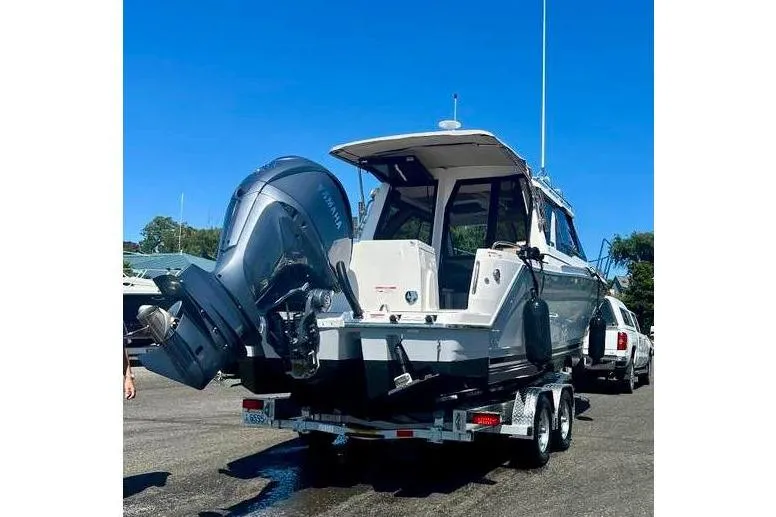 Slide: The Image of 2025 Cutwater C-248 Coupe boat on trailer, featuring dual outboard engines. - 4