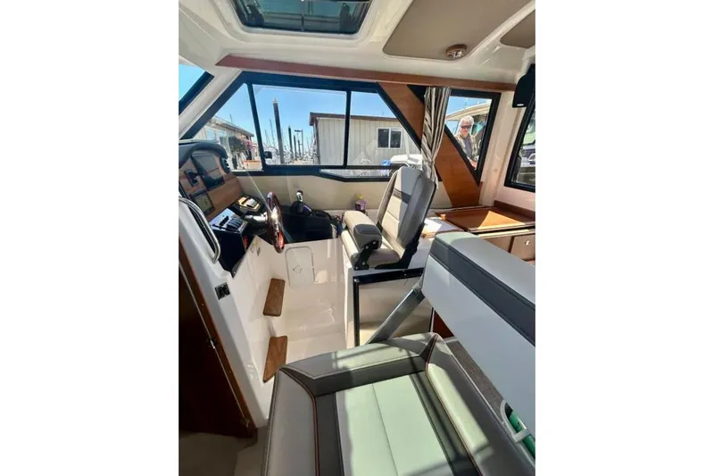 Slide: The Image of Interior view of 2025 Cutwater C-248 Coupe boat, showcasing seating and windows. - 9