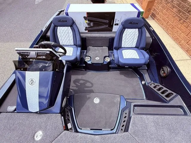 Slide: The Image of 2026 Ikon Boats LXE20 interior with blue seats and modern dashboard design. - 13