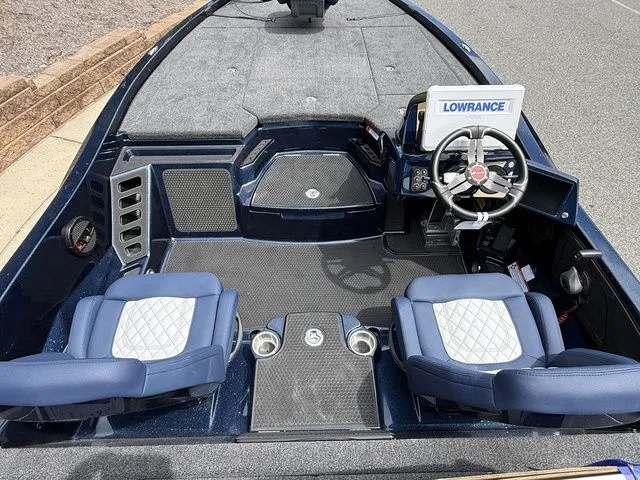 Slide: The Image of 2026 Ikon Boats LXE20 interior with blue seats, steering wheel, and Lowrance navigation system. - 5
