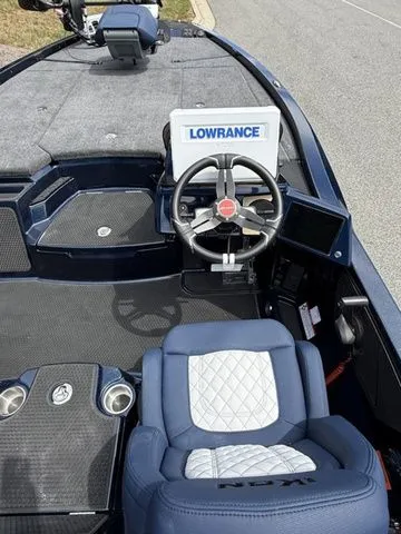 Slide: The Image of 2026 Ikon Boats LXE20 cockpit with Lowrance navigation system and blue seating. - 6