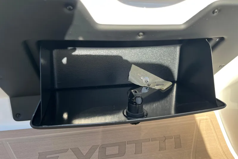 Slide: The Image of Storage compartment in 2026 Evotti 523CS boat, featuring key and plug. - 25