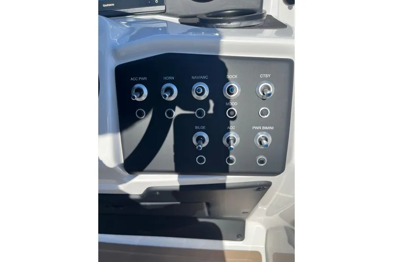 Slide: The Image of Control panel of 2026 Evotti 523CS boat with labeled switches and buttons. - 31
