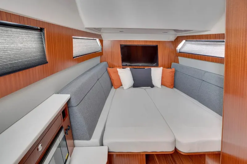 Slide: The Image of Manufacturer Provided Image: Luxurious cabin interior of 2025 Pursuit S 428 Sport boat with cozy seating and modern design. - 18