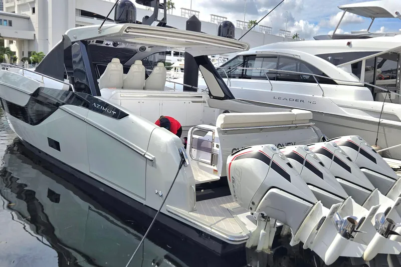 The Image of 2023 Azimut Verve 47 luxury yacht with multiple outboard engines docked at marina. - 0