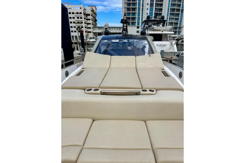 Slide: The Image of 2023 Azimut Verve 47 yacht with beige sunbed, docked in a marina. - 13