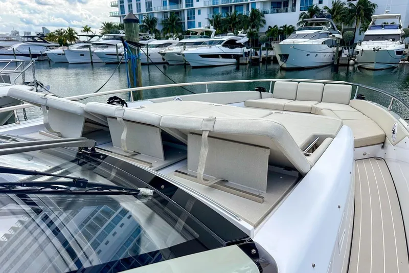 Slide: The Image of 2023 Azimut Verve 47 yacht with luxurious sunbathing area in marina setting. - 16