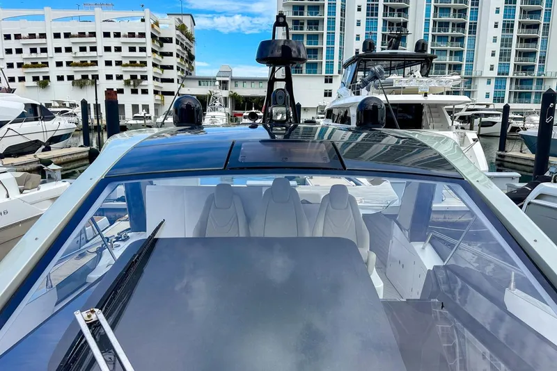 Slide: The Image of 2023 Azimut Verve 47 yacht docked at marina with modern buildings in background. - 18