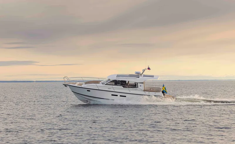 The Image of Nimbus 365 Coupe 2025 cruising on open water at sunset. - 0