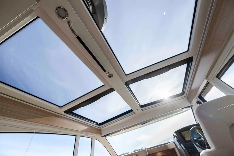 Slide: The Image of Sunlit interior of 2025 Nimbus 365 Coupe with panoramic sunroof and modern design. - 11