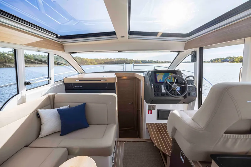 Slide: The Image of Luxurious interior of 2025 Nimbus 365 Coupe yacht with panoramic windows and modern helm. - 12
