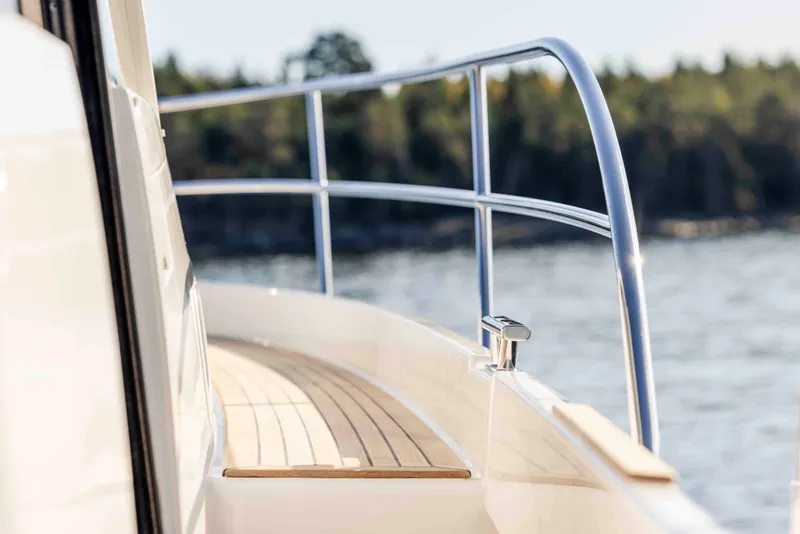 Slide: The Image of Side view of 2025 Nimbus 365 Coupe yacht with sleek railing and wooden deck. - 7