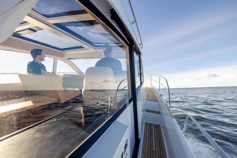 Slide: The Image of 2025 Nimbus 365 Coupe cruising on open water under clear skies. - 8