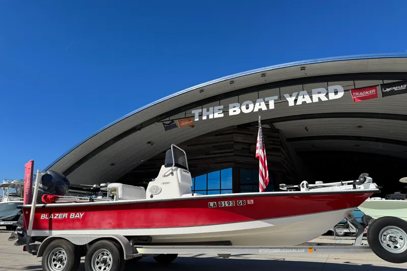 Slide: The Image of 2014 Blazer Bay 2170 boat on trailer at The Boat Yard, clear blue sky. - 1